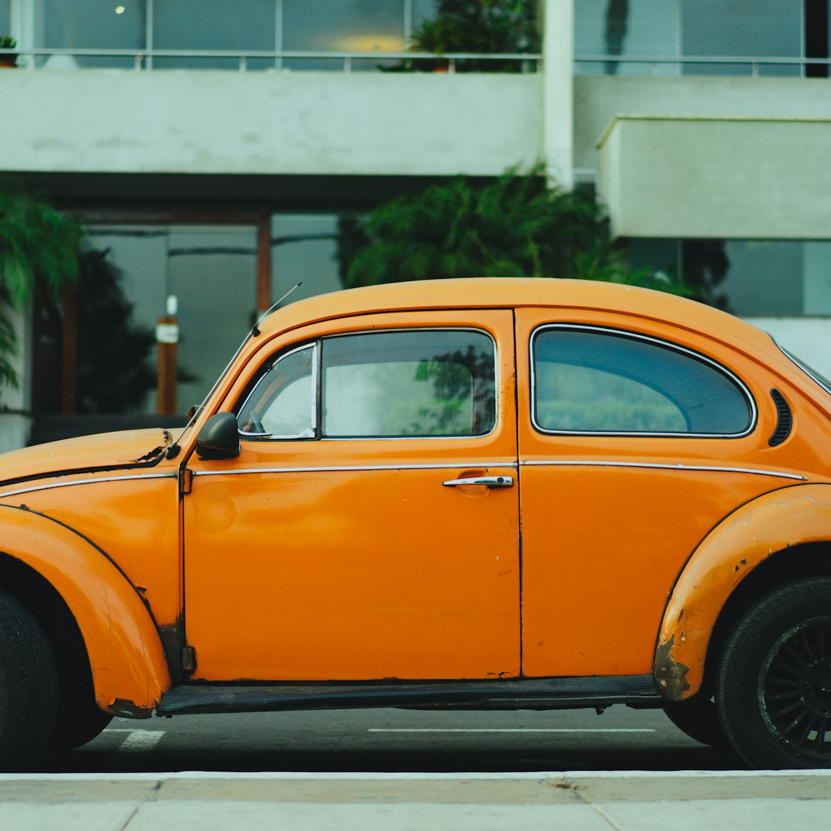 Orange first car parked after a driving test pass